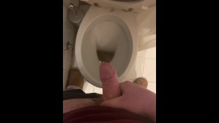 a guy pisses and then masturbates in the bathroom, cumming with his nice cock all over the place