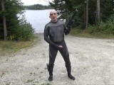 wetsuited silicone masked man on patrol near lake