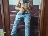 Horny Latino jerking off his thick cock in the bathroom mirror