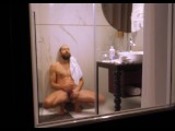 Mature dude filmed from outside while taking a shower and jerking off his hard cock