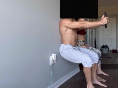 Fit couple doing wall squats to failure