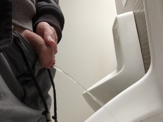 Guy Piss at Public Toilet