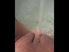 Jerking my big clit with a jet of water in the bathroom
