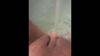 Jerking my big clit with a jet of water in the bathroom