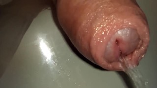 extreme close up foreskin of uncutted cock while peeing
