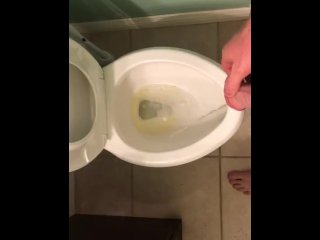 Taking a long Pee in the toilet.