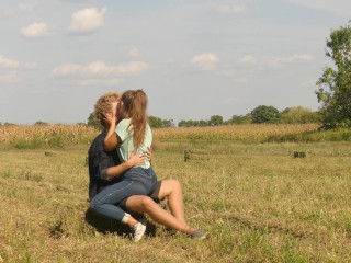 Beautiful Teen Couple in Love Passionately Kissing on the Field