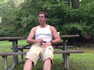 Masturbating in the public park next to the busy road.