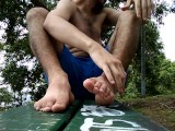 Seated in a bench teasing with my feet and toes