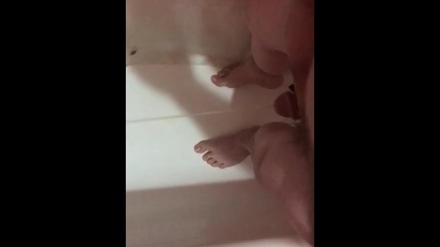 Pissing in the tub before shower ends in cum shot