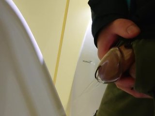 Pissing at the urinal while caged 