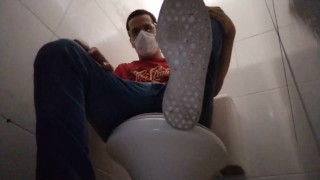 seated in the public toilet to show my dirty shoes