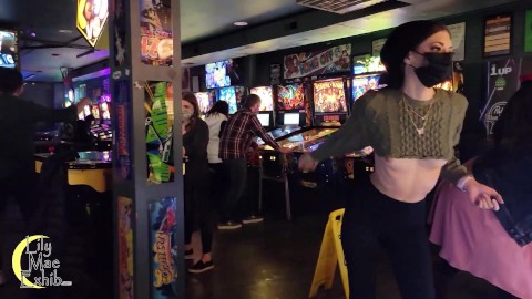 Brazenly flashing boobs in a busy arcade