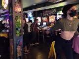 Brazenly flashing boobs in a busy arcade