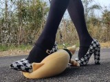 Outdoor transvestite stuffed animal is stomped and trained with high heels
