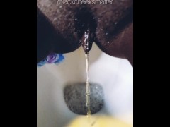 Ebony wife peeing a golden stream