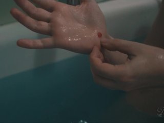 Lily plays with the showerhead while she takes_a bath