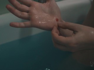 Lily plays with the showerhead while she takes_a bath