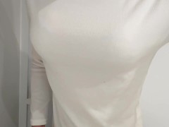 Fake boobs crossdresser is wearing sweater. Bra is seen through.