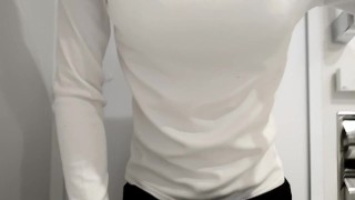 Fake boobs crossdresser is wearing sweater. Bra is seen through.