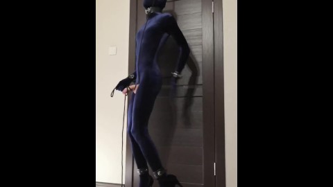 Crossdresser in velvet zentai and high heels hanging breathplay