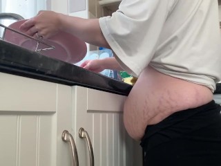 Newly pregnant slut washing the dishes showing off her new bump