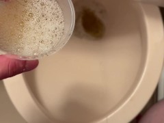 Pissing in a plastic cup.