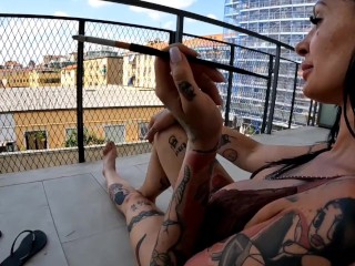 Two girlfriends smoke a cigarette