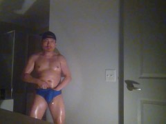 Oiled up and posing while wearing Speedos!
