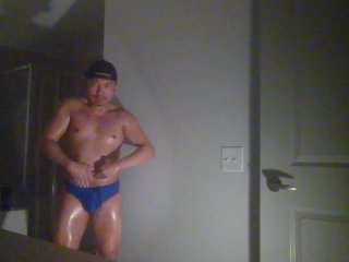 Oiled up and posing while wearing Speedos!