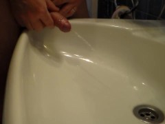 John is Peeing into the Bathroom Sink