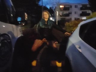 MILF pissing and playing with her pussy  in public parking at a fair