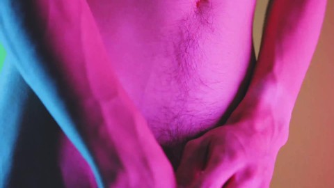 Sensual moves on colored background, showing bulge and hairy soft cock