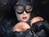 Girl with big boobs encased in black rubber latex catsuit enjoys bucket of hot cumm - part 2