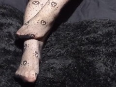 Close up of Wolf's cute feet in skull fishnets for your foot fetish pleasure
