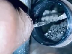 Pissing into the 500ml full bottle at a stretch  in the sink with clear pee 