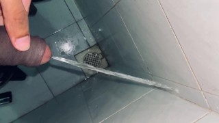 Orinando en el baño público sucio borde