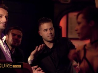 Nikita Bellucci in front of 4 men