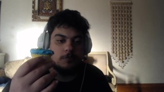 eating a blue frosted sprinkled cupcake from the local bakery