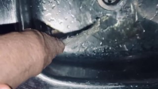 Uncut dick is pissing into the room sink from above 