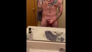 Stoking cock while in front of mirror. 