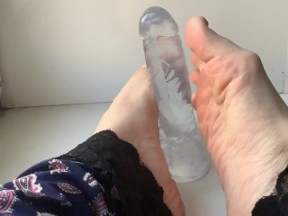Foot Fetish. Beautiful Legs and a Transparent Dildo, on the Windowsill