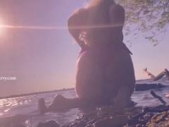 Bikini butt teasing in the water at a public beach! 