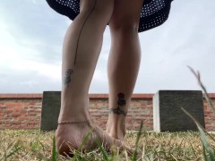 Slow motion milf barefoot in grass