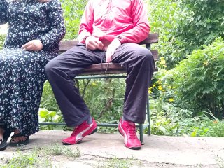 Hot MILF jerks off a big dick into a glass in the park on a bench