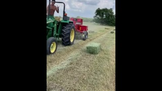 farmer joe pounding hay on tractor 