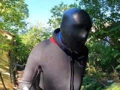 With closed latex-mask and neopren-suit at pool
