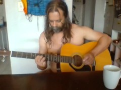 Naked guy playing guitar
