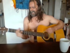 Naked guy playing guitar
