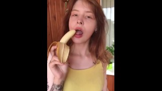 She shows her breasts and eats a banana sexually.